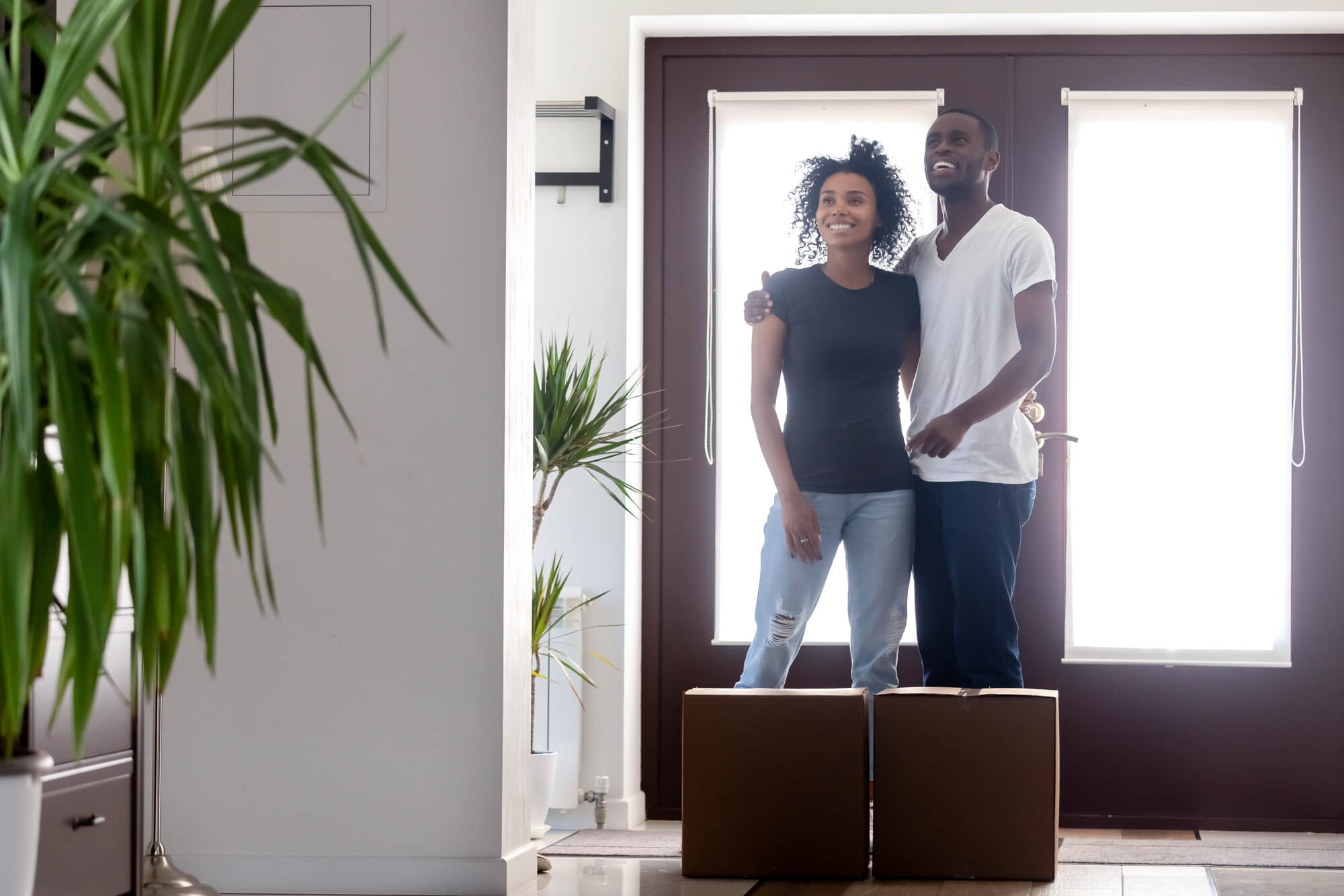 couple standing in doorway with boxes