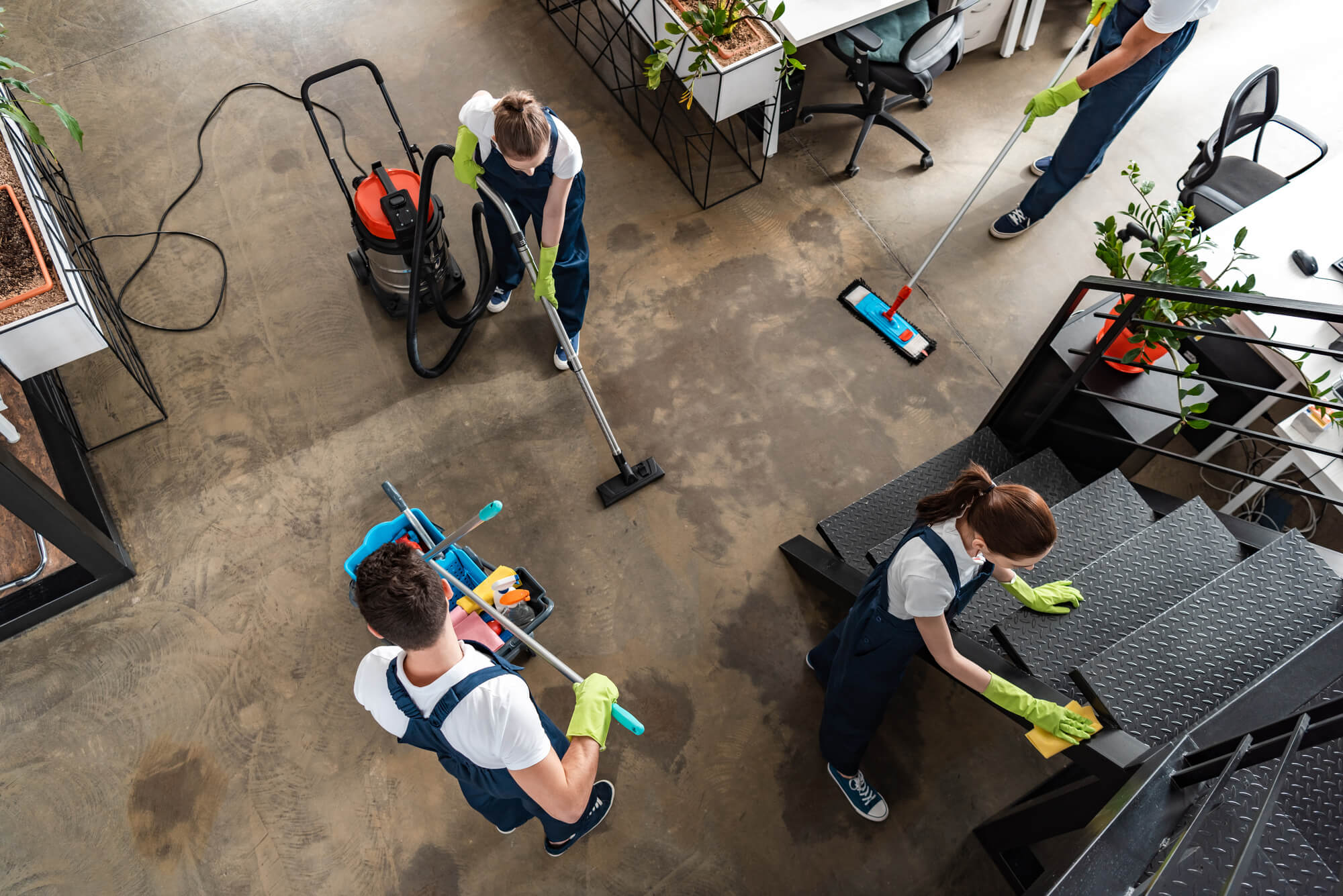 three people cleaning an office
