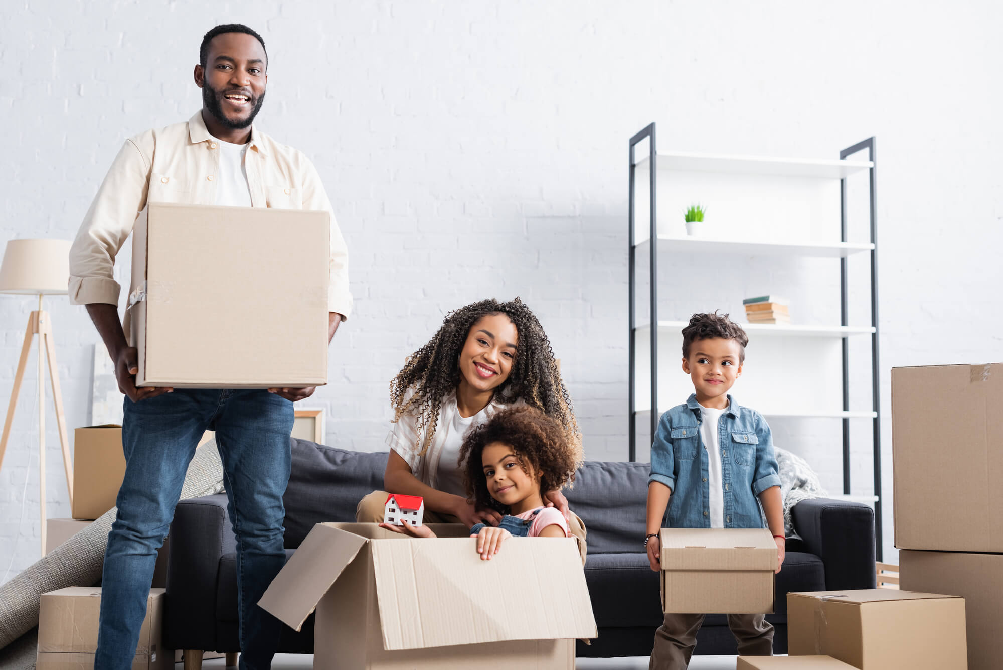 family of four packing boxes